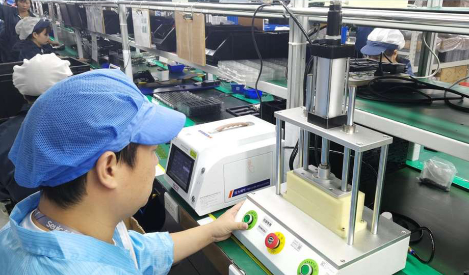 Barway Barcode employees conducting quality checks on barcode and RFID devices in the production facility.